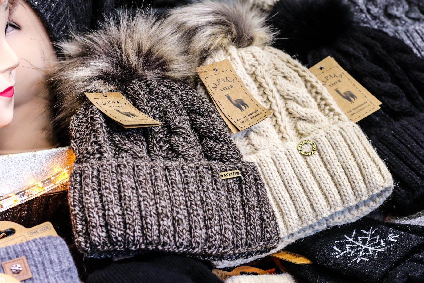 Strickmützen mit Fellbommel und Alpaka-Etikett bei Astrid Siebenhandel am Weihnachtsmarkt Mirabellplatz