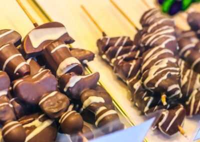 Schokofrüchte am Spieß mit weißen Schokostreifen in der Auslage von Ludwig Glier